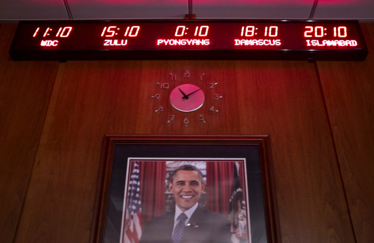 Image: Image:  A world clock and a portrait of President Barack Obama on one wall of the CIA Director's conference room.
