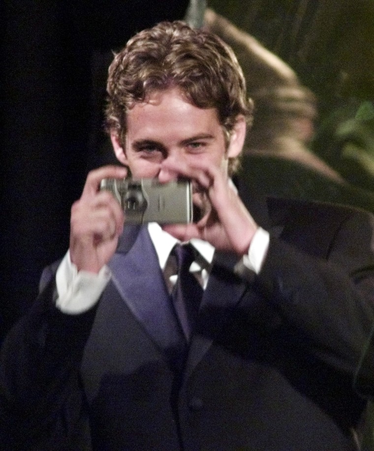 Image: PAUL WALKER PHOTOGRAPHS THE AUDIENCE AT HOLLYWOOD FILM FESTIVAL.