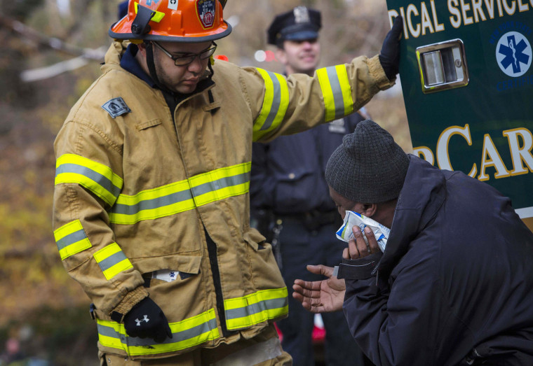 Image: A victim is treated following a train crash in New York