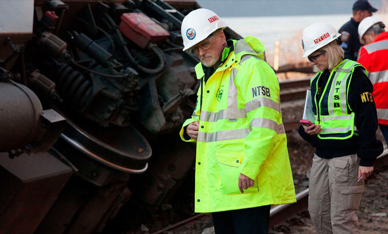 NTSB Investigator Michael Flanigon inspects track at the scene of the Metro North train derailment.