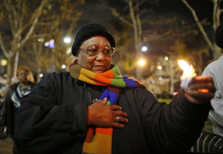 Image: Gracie Taylor participates in a candlelight vigil in memoriam of Nelson Mandela's death, in Los Angeles