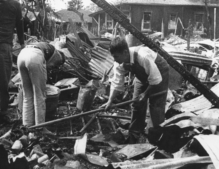 Hawaii residents comb thru wreckage on Dec. 17, 1941 after Japanese bombing raids on December 7. (AP Photo)