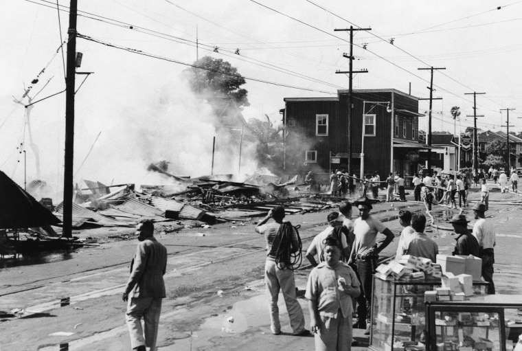The wreckage of a drug store smolders at Waikiki after attack by Japanese planes, Dec. 7 1941. (AP Photo)
