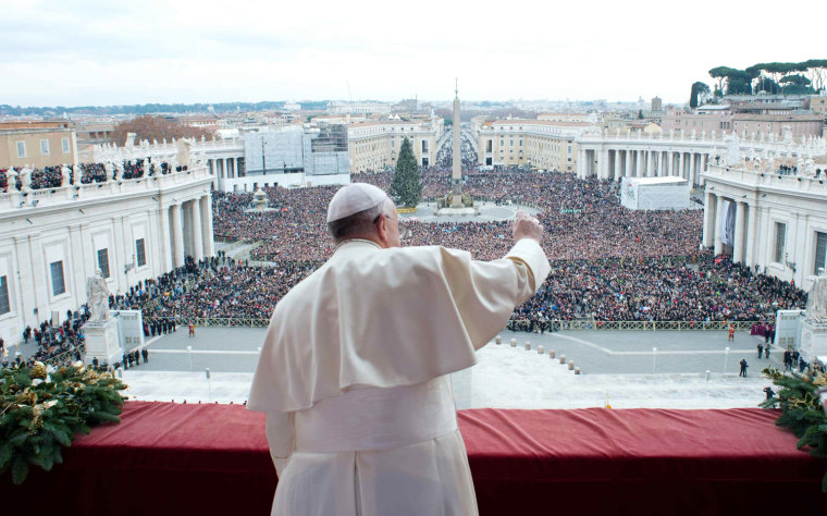 Image: Pope Francis waves as he delivers his first \"Urbi et Orbi\" message from the balcony overlooking St. Peter's Square at the Vatican