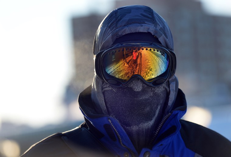 Image: Chris Griesmeyer dons ski goggles and a mask to protect him from the harsh wind chill