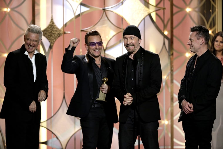 Image: U2 receives their award during the 71st annual Golden Globe Awards in Beverly Hills