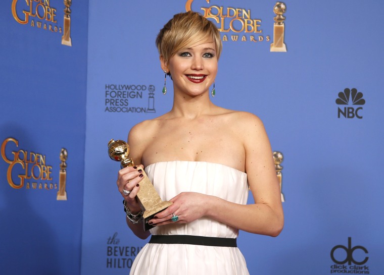 Image: Actress Jennifer Lawrence poses with her award for Best Supporting Actress in a Motion Picture for her role in the film \"American Hustle\" backstage at the 71st annual Golden Globe Awards in Beverly Hills