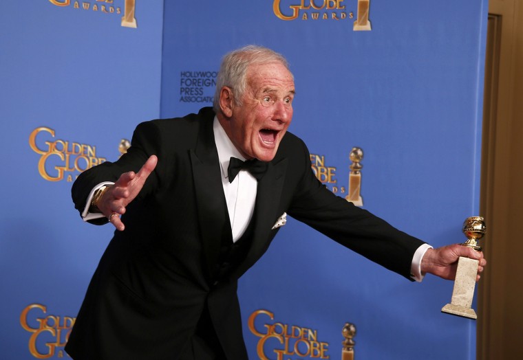 Image: Producer Jerry Weintraub poses backstage with the award for Best TV Movie or Mini-Series for \"Behind the Candelabra\" at the 71st annual Golden Globe Awards in Beverly Hills