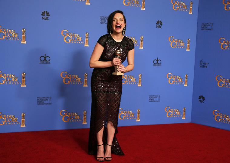 Image: Actress Elizabeth Moss poses with her award for Best Actress in a Mini-Series or TV Movie for her role in \"Top of the Lake\" backstage at the 71st annual Golden Globe Awards in Beverly Hills