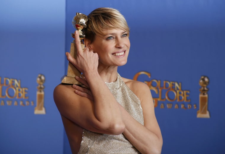 Image: Actress Robin Wright poses with the award for Best Actress in a TV Series, Drama for her role in \"House of Cards,\" backstage at the 71st annual Golden Globe Awards in Beverly Hills