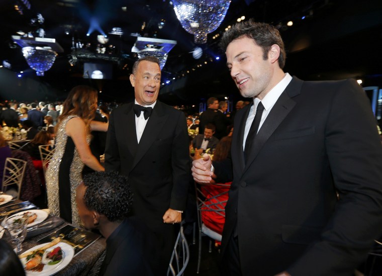 Image: Actors Hanks and Affleck chat during a commercial break at the 20th annual Screen Actors Guild Awards in Los Angeles