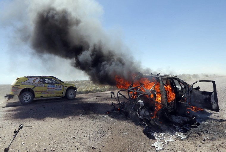 Image: Burning car at Dakar Rally.