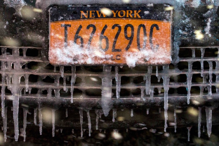 Image: A snow and ice covered license plate is seen on a taxi in Times Square during a snow storm in Manhattan in New York