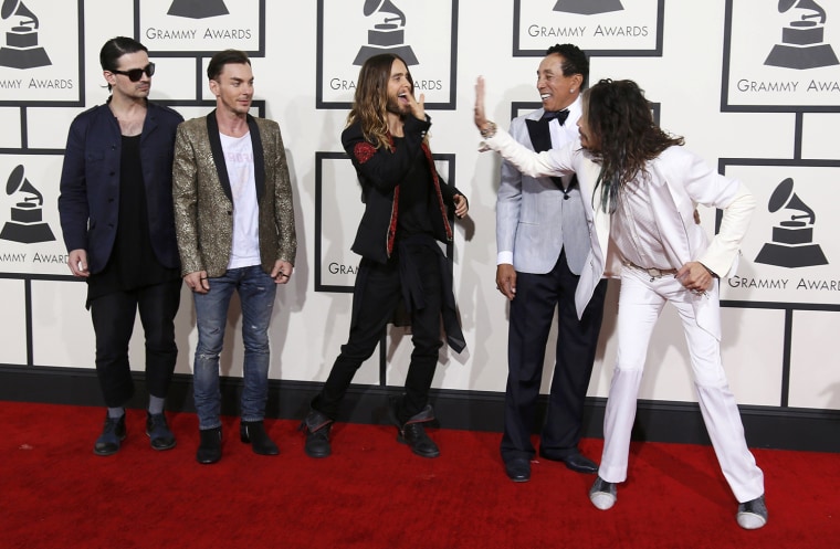 Image: Tyler high fives Leto as Robinson watches as they arrive at the 56th annual Grammy Awards in Los Angeles