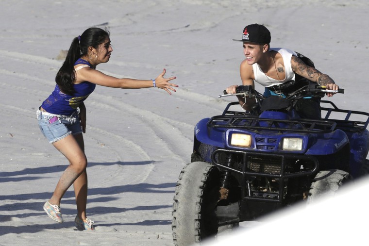 Image: Canadian pop singer Justin Bieber greets a fan at a resort in Punta Chame on the outskirts of Panama City