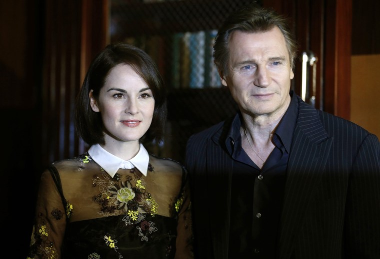 Image: Cast members Michelle Dockery and Liam Neeson pose during a media event to promote the film \"Non-Stop\", in London