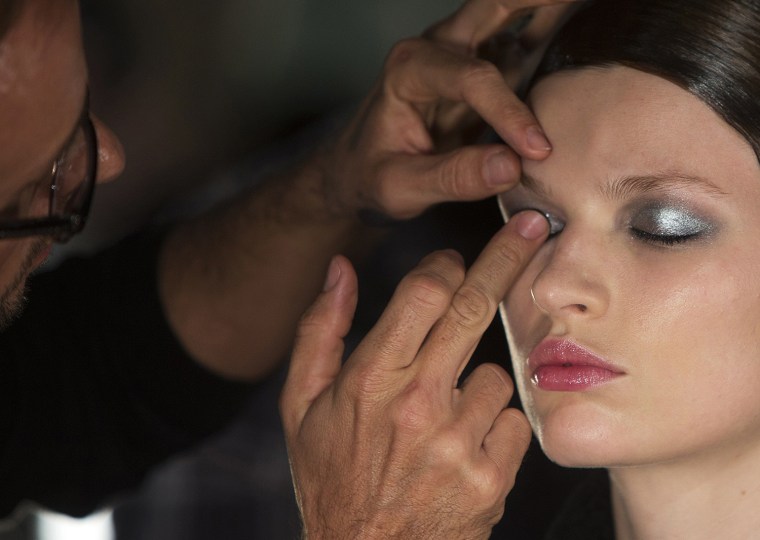 Image: A model has makeup applied backstage before the Donna Karan New York show during New York Fashion Week