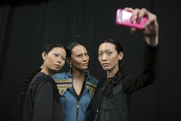 Image: Models take a \"selfie\" at the Katya Zol 2014 Fall/Winter collection presentation during New York Fashion Week in New York
