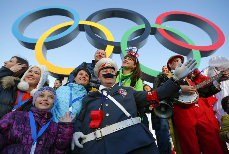 Image: Fans cheer underneath the Olympic rings during the Sochi 2014 Winter Olympics Games