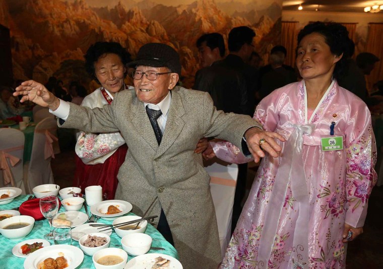 Image: South Korean Yoo Youn-sik dances at a welcome dinner with his North Korean family members during their family reunion at the Mount Kumgang resort in North Korea