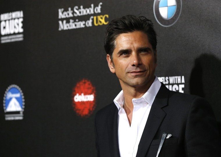 Image: John Stamos poses at second annual \"Rebels With a Cause\" gala at Paramount Pictures Studios in Los Angeles