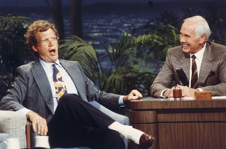 Talk show host David Letterman, left, gestures while talking with Johnny Carson during taping of the ?Tonight Show? at the NBC Studio in Burbank, California on August 30, 1991. Letterman?s presence on the ?Tonight Show? was his first appearance since Carson announced his retirement next year. Letterman and Jay Leno, who is Carson?s regular guest host and was named as his replacement, were in contention for the job. (AP Photo)