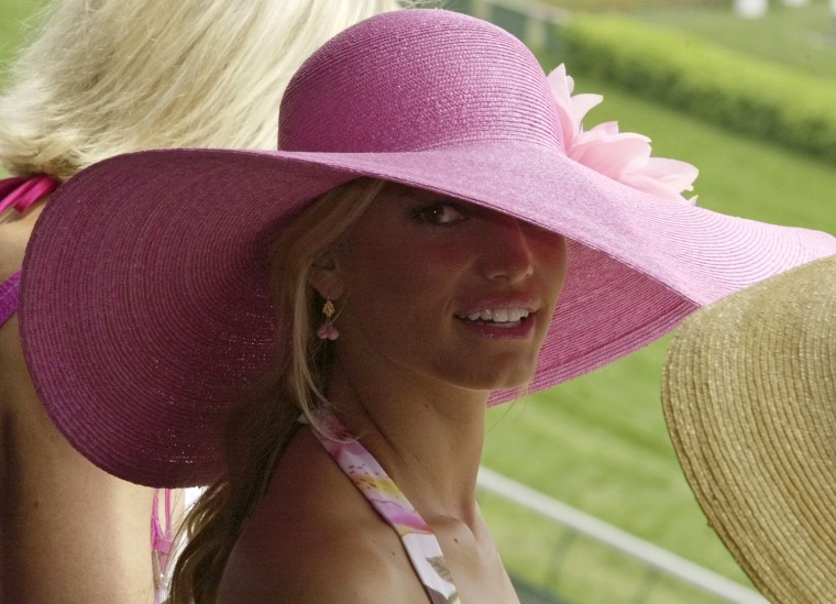Singer Jessica Simpson wears a colorful hat during Kentucky Derby day festivities at Churchill Downs, Saturday, May 1, 2004, in Louisville, Ky. (AP Photo/Darron Cummings)