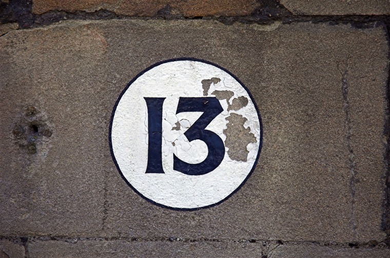 The number 13 as numerals on a stone wall. 
lucky or unlucky?