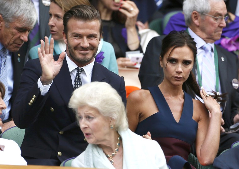 Image: David and Victoria Beckham sit on Centre Court at the Wimbledon Tennis Championships, in London