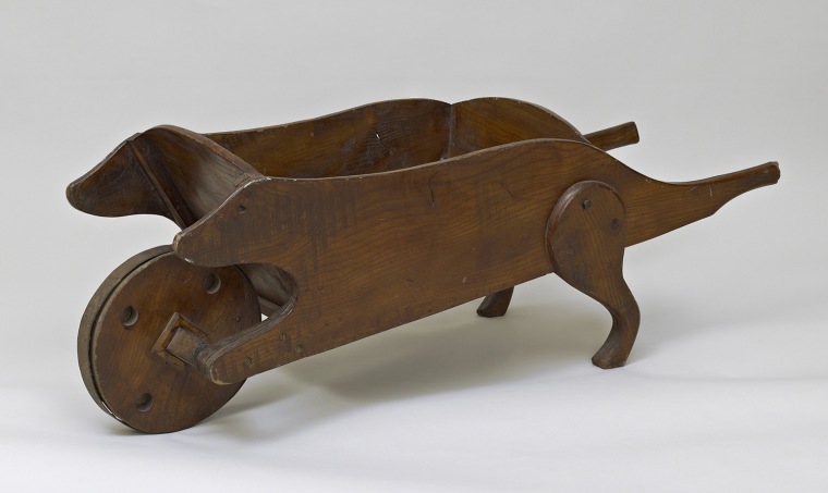 Wooden wheelbarrow in the shape of a dog, used for generations by Royal children