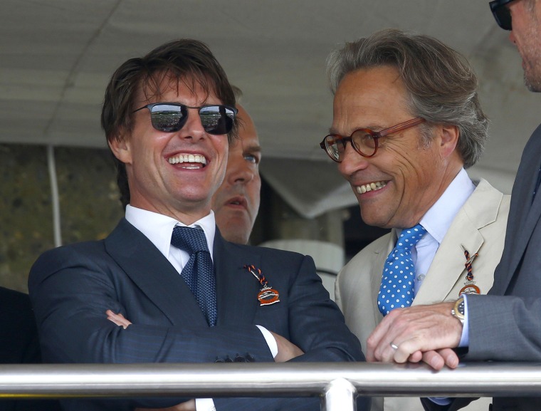 Image: Hollywood actor Cruise talks to Gordon-Lenox, Earl of March, at Goodwood racecourse