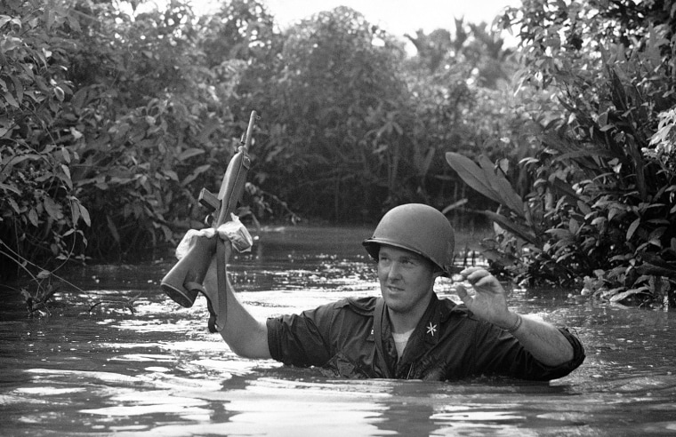 U.S. soldier crossing the river, wading neck deep in water through the waterholes during a day long operation with two Ranger companies in Gia Dinh province of Vietnam on March 10, 1964. Combing through the swampy area was slow and strenuous and several rivers had to be crossed. The Rangers made no contact with the estimated 200 regular Viet Cong in that area. (AP Photo/Horst Faas)