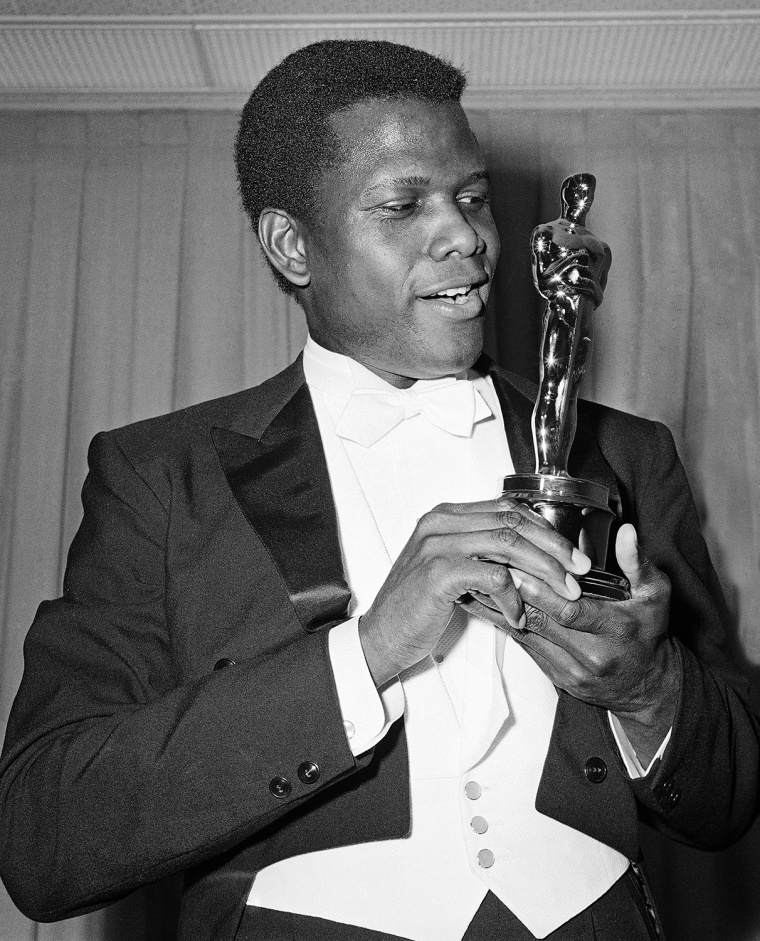 Actor Sidney Poitier is photographed with his Oscar statuette at the 36th Annual Academy Awards in Santa Monica, Calif. on April 13, 1964. He won Best Actor for his role in \"Lillies of the Field.\" (AP Photo)