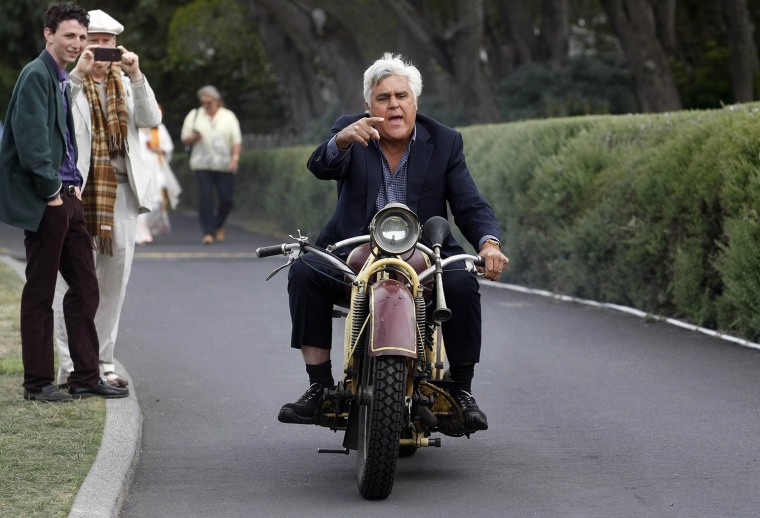 Image: Jay Leno rides a 1930 Bohmerland motorcycle around the grounds during the Concours d'Elegance at the Pebble Beach Golf Links in Pebble Beach