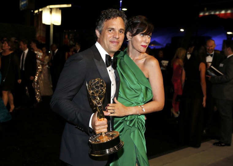 Image: Actor Mark Raffalo with his Outstanding Television Movie award for HBO's \"The Normal Heart\" and his wife, Sunrise Coigney, arrive at the Governors Ball for the 66th Primetime Emmy Awards in Los Angeles