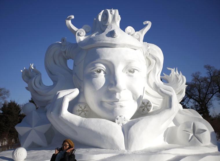 Image: Visitors walk past large snow sculptures during the Harbin International Ice and Snow Festival in the northern city of Harbin