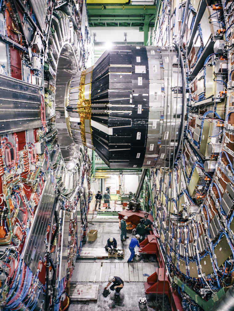 Last maintenance work inside The Compact Muon Solenoid (CMS), a general-purpose detector at the Large Hadron Collider (LHC). It is designed to investigate a wide range of physics, including the search for the Higgs boson, extra dimensions, and particles that could make up dark matter. Although it has the same scientific goals as the ATLAS experiment, it uses different technical solutions and a different magnet-system design.
The CMS detector is built around a huge solenoid magnet. This takes the form of a cylindrical coil of superconducting cable that generates a field of 4 tesla, about 100,000 times the magnetic field of the Earth. The field is confined by a steel ?yoke? that forms the bulk of the detector?s 12,500-tonne weight.
An unusual feature of the CMS detector is that instead of being built in-situ like the other giant detectors of the LHC experiments, it was constructed in 15 sections at ground level before being lowered into an underground cavern near Cessy in France and reassembled. The com