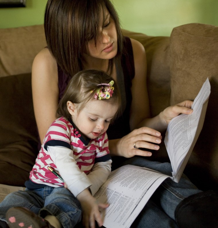 Ashley Van Wormer, 20, studies for a GED test in the company of her one-year-old daughter Payton in Elkhart, Indiana.