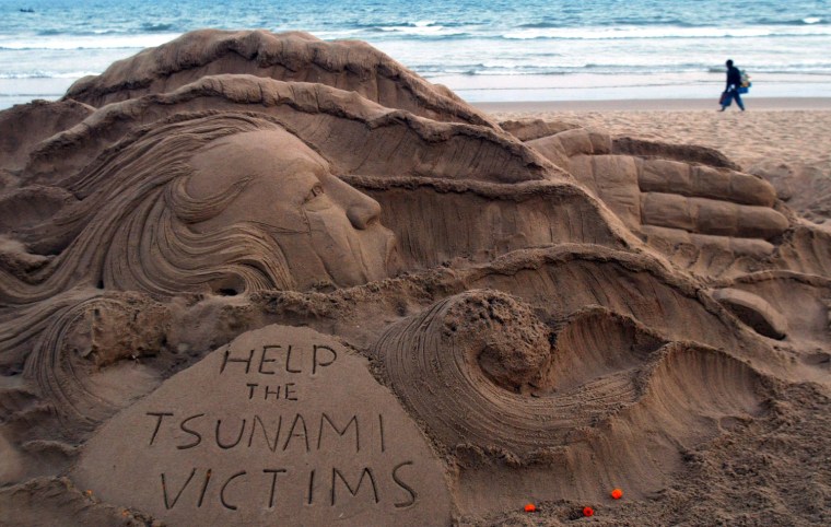 Image: A sand sculpture created by sand artist Sudarshan Pattnaik to create awareness about Tsunami that struck Japan on 11 March is photographed at Golden sea beach resort at Bhubaneswar
