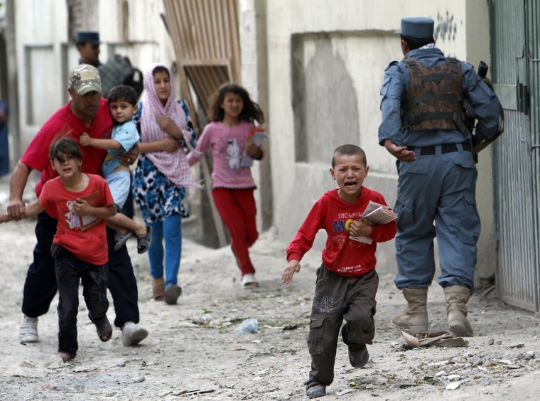 Image: Children run away after an explosion in Kabul