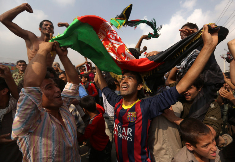 Image: Afghan football fans celebrate winning the South Asian Football Federation championship after their team defeated India during the final match, in Kabul