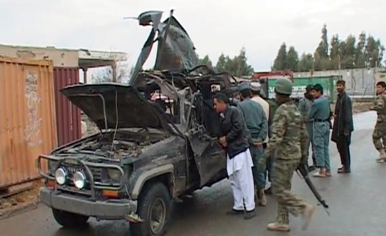 Image: A video grab shows security personnel examining the damaged vehicle belonging to the deputy governor of Afghanistan's southern Kandahar province, after an attack in Kandahar city