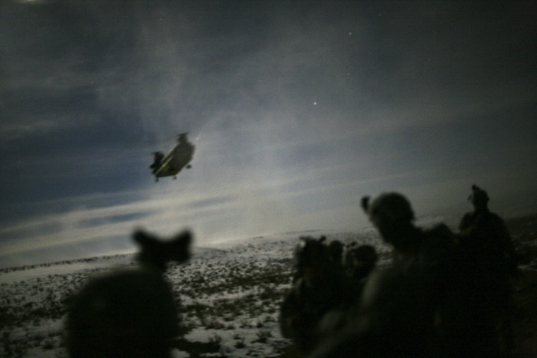 Image: A Chinook helicopter lands to pick up U.S. soldiers of the 101st Airborne Division following a night raid in Yahya Khel, Paktika province, Afghanistan