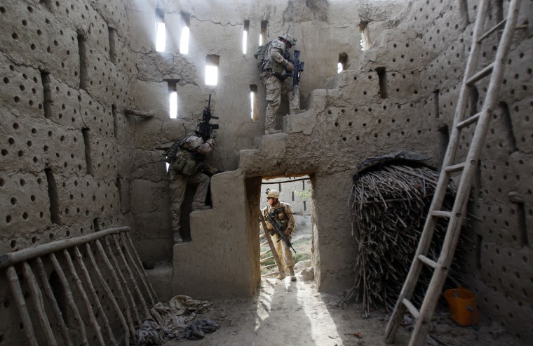 Image: Canadian soldiers search inside a barn during a patrol in the Panjwai district southern Afghanistan