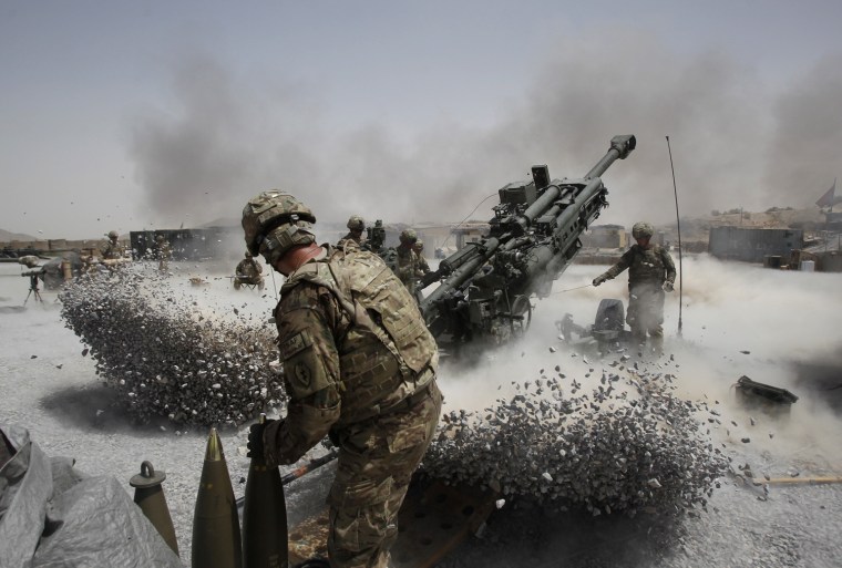 Image: U.S. Army soldiers from the 2nd Platoon, B battery 2-8 field artillery, fire a howitzer artillery piece at Seprwan Ghar forward fire base in Panjwai district
