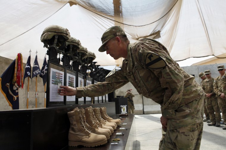 Image: U.S. Army Major General Daniel B. Allyn commander of ISAF RC (East) takes part during a memorial ceremony in forward firebase Joyce in Kunar province