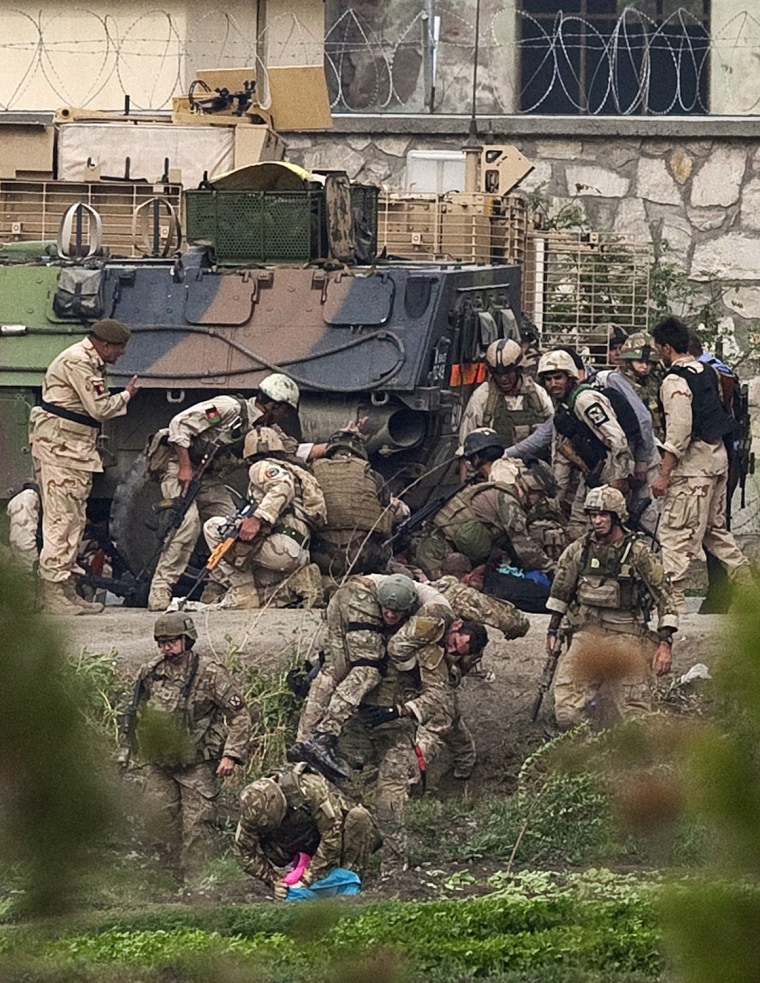 Image: NATO and Afghan troops attend to casualties during a battle with Taliban insurgents who took over a building near the U.S. embassy in Kabul