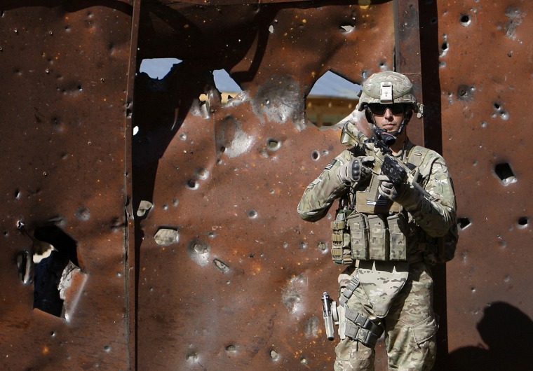 Image: U.S. soldier keeps watch at the site of a suicide attack in Panjshir province