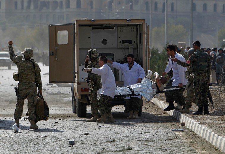 Image: A wounded U.S. soldier is carried away from the site of a suicide attack in Kabul