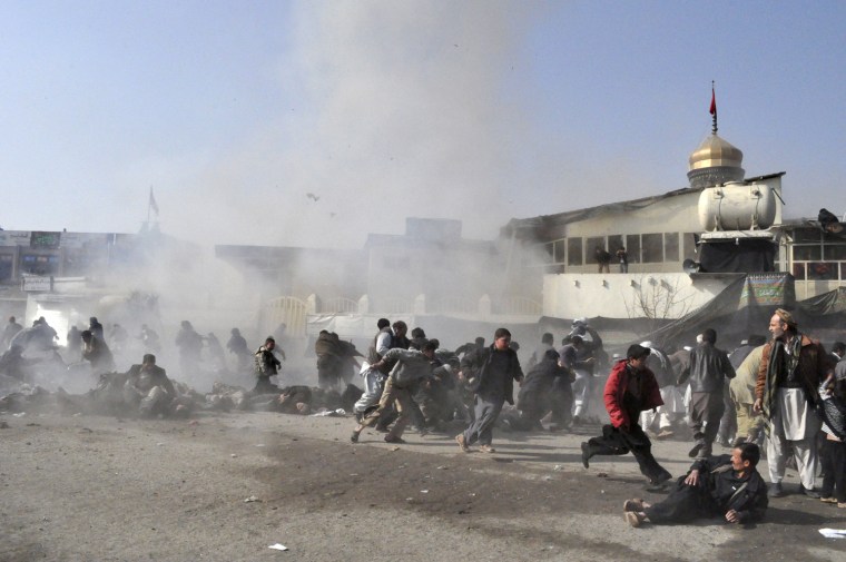 Image: People react seconds after a suicide blast targeting a Shiite Muslim gathering in Kabul